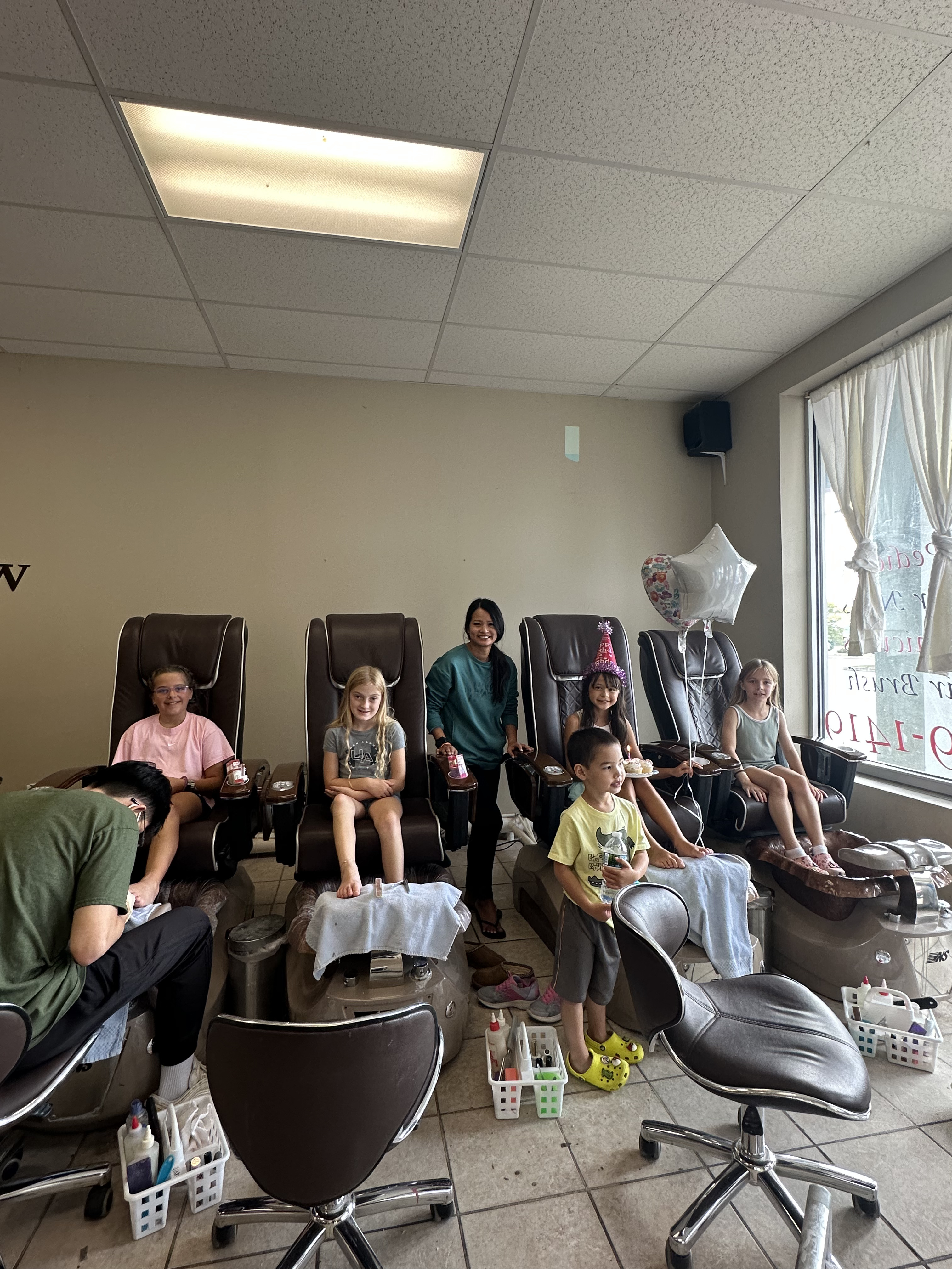 group photo of kids getting pedicures